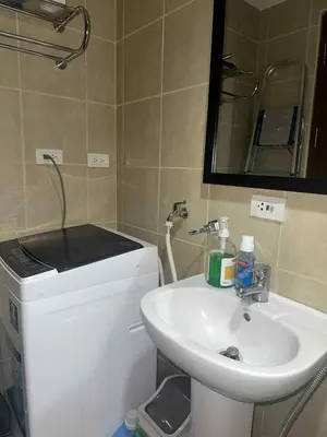 a bathroom with a sink and a mirror at Spacious Studio in Mosaic Tower no Balcony in Manila