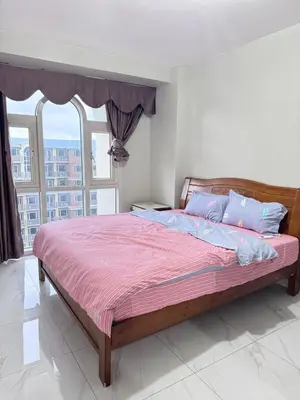 a bedroom with a large bed with a large window at Near Moa Facing pool view WP1603 Monarch Parksuites in Manila