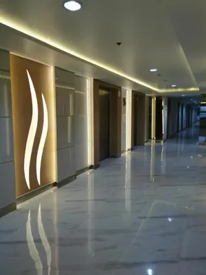 an empty hallway of a building with a sign on the wall at Mall of Asia condotel shore 3 residence in Manila