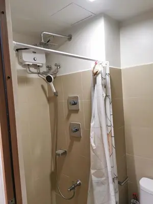 a shower in a bathroom with a shower curtain at Mall of Asia condotel shore 3 residence in Manila