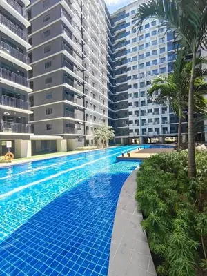 a swimming pool in front of some tall buildings at Mall of Asia condotel shore 3 residence in Manila