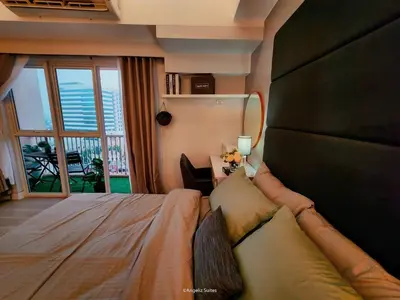 a bedroom with a large bed with a large window at One Bedroom Unit with Venice Canal View in Manila
