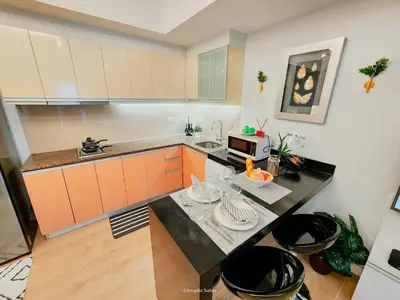 a kitchen with a counter top with a microwave at One Bedroom Unit with Venice Canal View in Manila