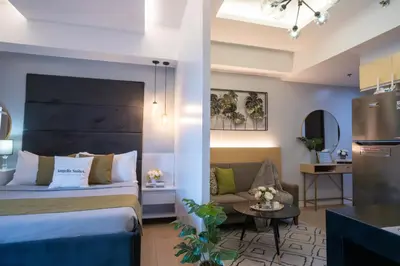 a hotel room with a bed and a couch at One Bedroom Unit with Venice Canal View in Manila