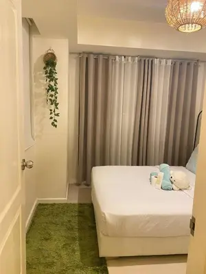a small bedroom with a bed and a window at Azure Staycations by MM 1 in Manila