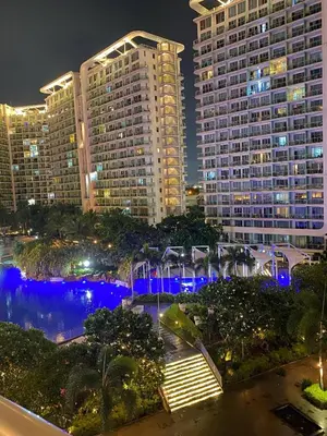 a view of a city at night with tall buildings at Azure Staycations by MM 1 in Manila