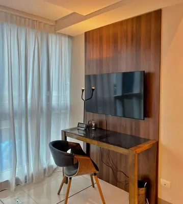 a room with a desk with a television and a chair at Cozy Netflix and Chill in BGC in Manila