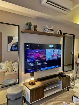a large flat screen tv in a living room at Cozy Netflix and Chill in BGC in Manila