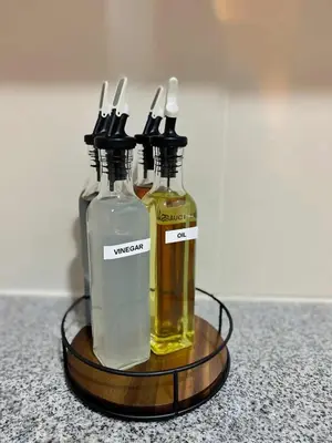 two bottles of olive oil on a wooden tray at Cozy Netflix and Chill in BGC in Manila