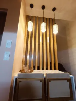 a table with two chairs and two lights at Regalia's Pod in Trece Martires