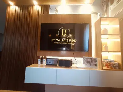 a room with a tv on top of a counter at Regalia's Pod in Trece Martires