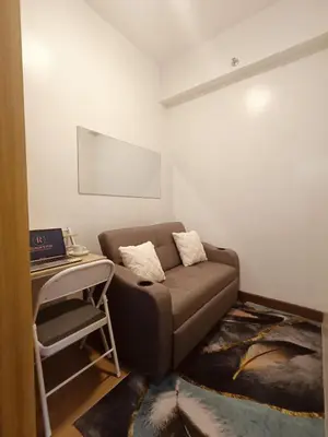 a living room with a couch and a table at Regalia's Pod in Trece Martires