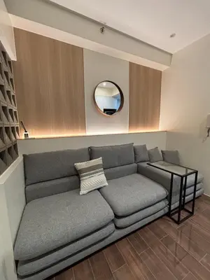 a living room with a couch and a mirror at Yanah Stays in Manila