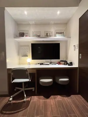 a computer desk with a monitor and a chair at Yanah Stays in Manila