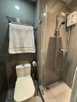 a bathroom with a toilet and a shower at Yanah Stays in Manila