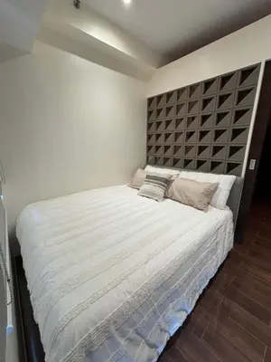 a bedroom with a large bed with a large headboard at Yanah Stays in Manila