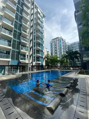 two people in a swimming pool in a city at Affordable Condoatel Hotel Near Naia 1,2,34 in Manila