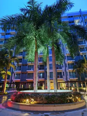 a palm tree in front of a building at Affordable Condoatel Hotel Near Naia 1,2,34 in Manila