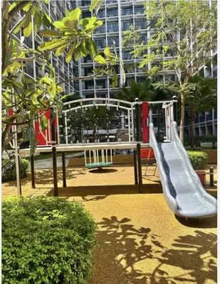 a playground with a slide in front of a building at Cozy Condo Staycation with Balcony near Mall of Asia in Manila