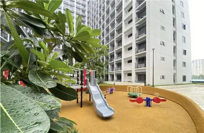 a playground with a slide in the middle of a building at Cozy Condo Staycation with Balcony near Mall of Asia in Manila