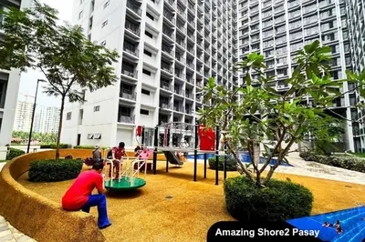 a child playing in a playground in a city at Cozy Condo Staycation with Balcony near Mall of Asia in Manila
