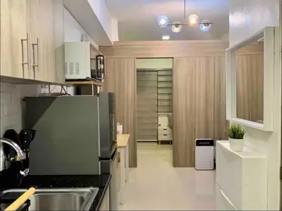 a kitchen with a sink and a refrigerator at Fame Residences One-Bedroom Condo Unit in Manila