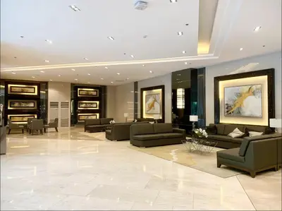 a large lobby with couches and chairs in a building at Fame Residences One-Bedroom Condo Unit in Manila