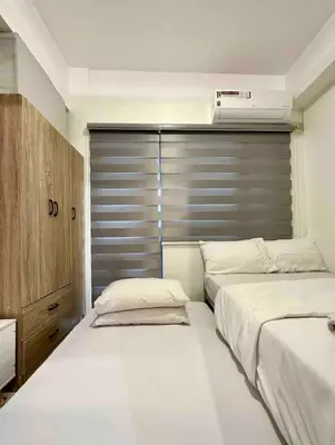 two beds sitting next to each other in a bedroom at Fame Residences One-Bedroom Condo Unit in Manila
