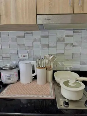 a kitchen counter with utensils on a counter top at Aurbana Staycation in Manila