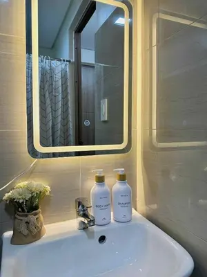 a bathroom sink with two bottles of soap on it at Aurbana Staycation in Manila
