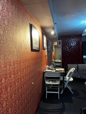 a room with red walls and a table and a chair at Vintage Luxx-Solemare Parksuites Free Pool Access! in Manila