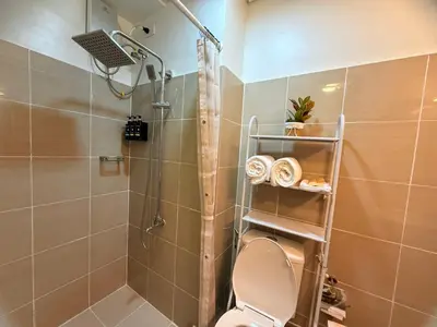 a bathroom with a shower with a toilet and a shower at Shore 2 Residences Tower 3 by HappyHaven in Manila