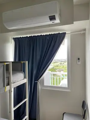 a room with a bunk bed and a window at Jade Loft in Manila