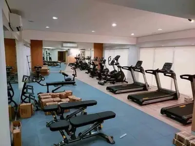a gym with rows of exercise bikes and treadmills at Jade Loft in Manila
