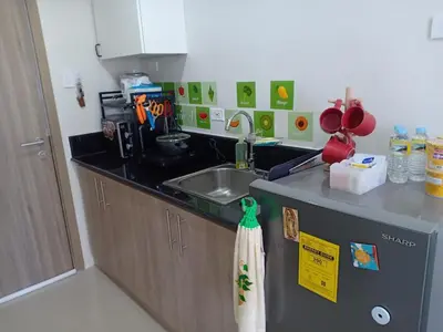 a kitchen counter with a sink and a towel at Jade Loft in Manila