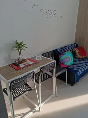 a table and a couch in a room at Jade Loft in Manila