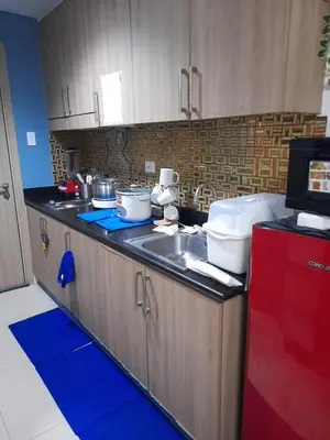 a kitchen with a sink and a counter top at Shore Residences Tower B near MOA and IKEA Pasay City in Manila