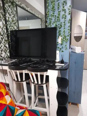 a computer desk with a monitor on top of it at Shore Residences Tower B near MOA and IKEA Pasay City in Manila