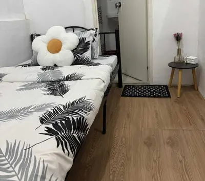 a black and white bed with a teddy bear on it at OYO 1155 Carnivale Inn in Manila
