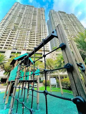 a playground in front of a tall building at Condo in Pasay 12th flr studio unit-near MOA, PICC in Manila