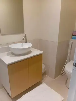 a bathroom with a sink and a toilet at Condo in Pasay 12th flr studio unit-near MOA, PICC in Manila
