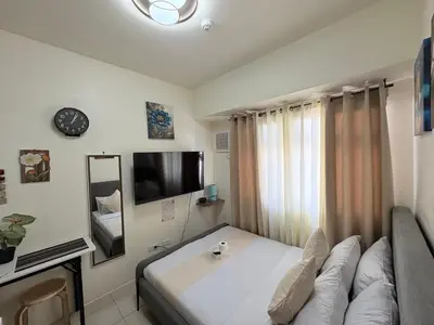 a living room with a couch and a tv at JJMC PLACE 28 With Netflix and Unli Wifi in Manila