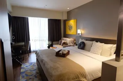 a hotel room with a large bed and a piano at Acqua at The Hotel Residences Acqua Manila near Makati and BGC in Manila