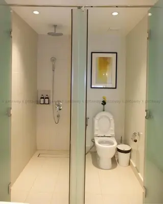 a bathroom with a toilet and a shower at Acqua at The Hotel Residences Acqua Manila near Makati and BGC in Manila