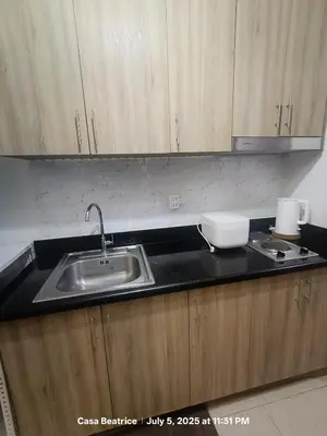 a kitchen with a sink and a counter top at Cozy 19 at Shore 2 Residences in Manila