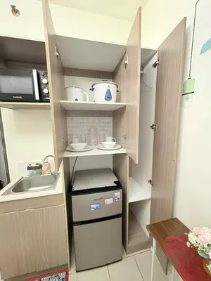 a small kitchen with a sink and a counter at JJMC HOMESTAY 29 with Netflix and Wifi in Manila