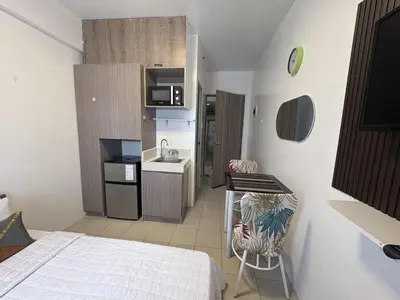 a small room with a bed and a kitchen at JJMC PLACE 36 With Netflix and Unli Wifi in Manila