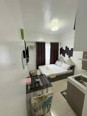 a small room with a bed and a table at JJMC PLACE 36 With Netflix and Unli Wifi in Manila