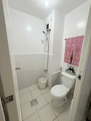 a small bathroom with a toilet and a shower at JJMC PLACE 36 With Netflix and Unli Wifi in Manila