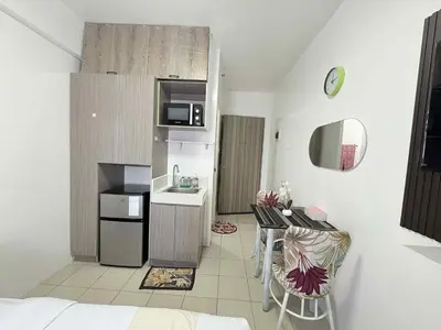 a small kitchen with a small table and a kitchen with a kitchen at JJMC PLACE 36 With Netflix and Unli Wifi in Manila